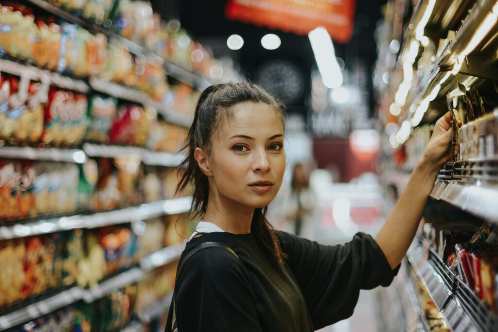 woman selecting packed food on gondola used for how to open an etsy store article